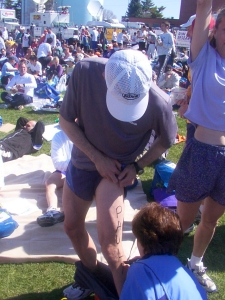 Race preparation with total strangers: Chris had no trouble finding female volunteers to write stuff on his body.